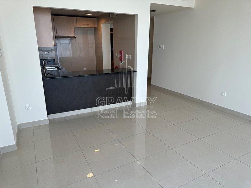 well-kept-open-kitchen-area-and-the-entrance-door-sun-tower-apartment-for-sale