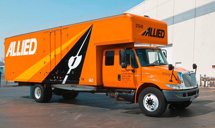 orange-allied-vans-truck-parked-outside-a-warehouse