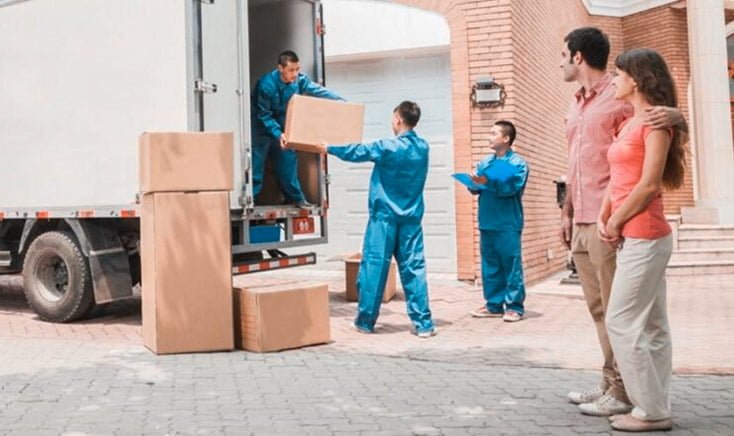 movers-unloading-boxes-from-truck-for-young-couple