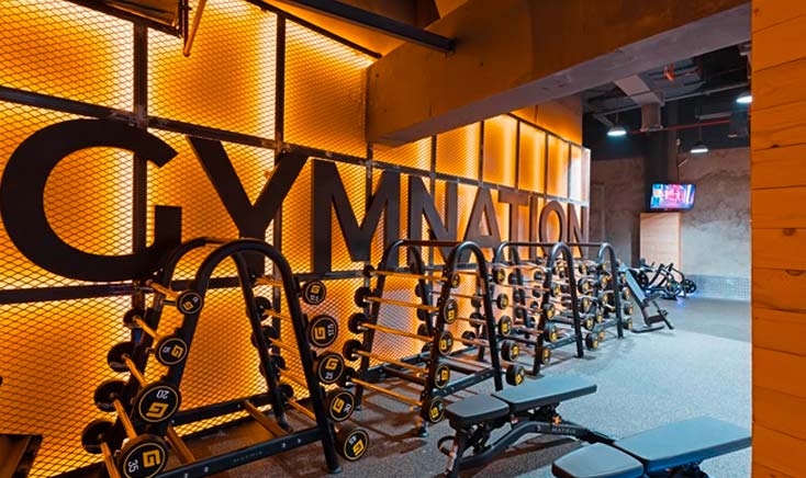 gymnation-the-best-gym-in-reem-island-giant-logo-with-weight-rack-in-front