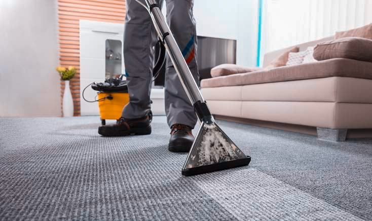 Kleen-tech-employee-using-high-tech-equipment-to-clean-an-apartments-carpet