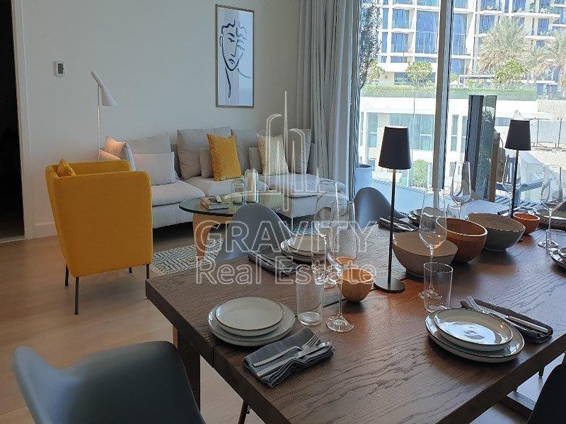 cozy-living-hall-area-with-nice-dinning-table-with-glass-and-plates-and-nice-sofa-mamsha-al-saadiyat