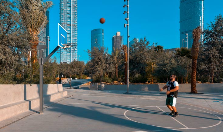 Pilipino-man-shooting-a-basketball-towards-a-hoop-in-fay-park