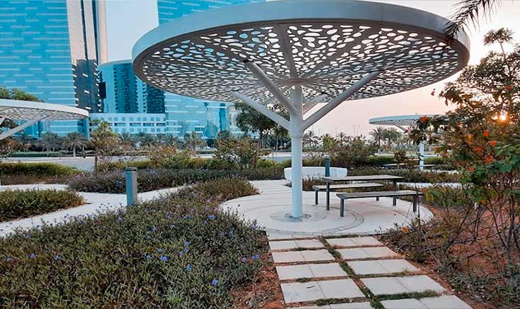 shaded-sitting-areas-surrounded-by-flowers-during-sunset-in-reem-central-park