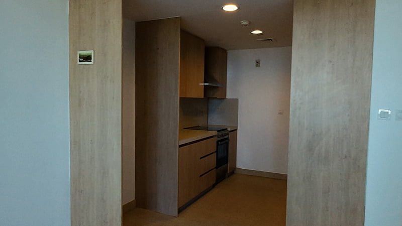 angled view wooden kitchen cabinet and granite countertop