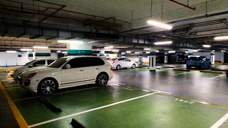 cars parked in underground parking area in Al Zeina Residence