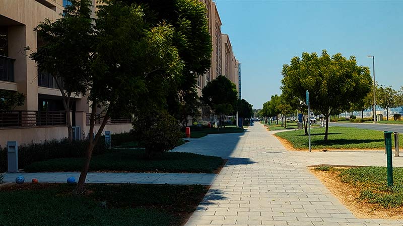 trees and walkway outside near the building in al zeina