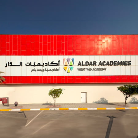 red facade with logo of the Yas American Academy near al zeina