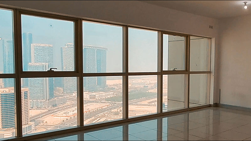 street view from above inside the flat with large windows blue tower abu dhabi