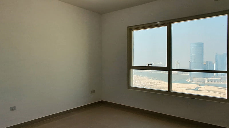 empty room with windows of marina blue tower reem island