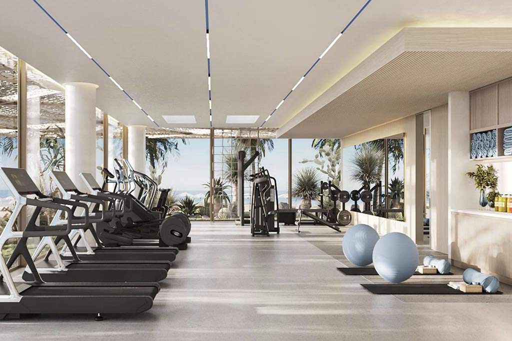 treadmills and gym equipment inside the dedicated gym of Nikki Beach Residences Al Marjan