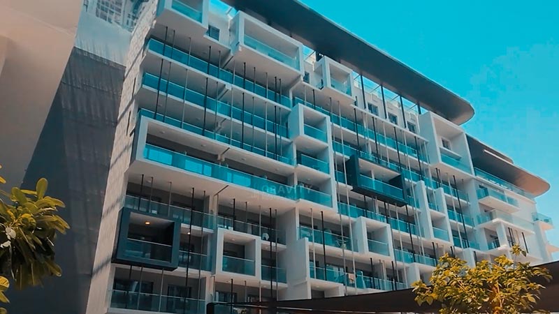 view of the Oasis 1 from the outside showing balconies made of glass