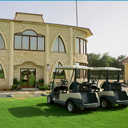 2 golf carts parked in front of the building