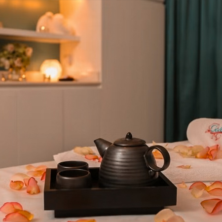 teapot on a bed with flowers