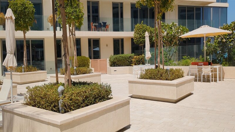 outside seats and landscaped plants in Mamsha Al Saadiyat