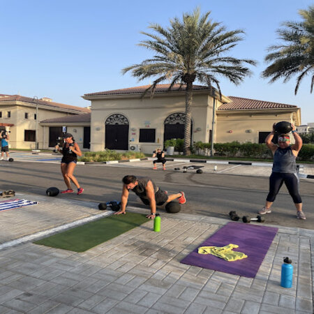 men and women doing exercises outside the villa