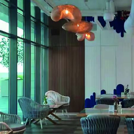 elegant chairs and chandelier inside a restaurant