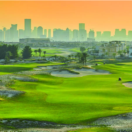 Golf course overlooking city buildings